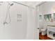 Clean and modern bathroom with a white tile shower and view of the stylish vanity and toilet at 509 W Ashley Ave, Folly Beach, SC 29439