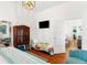 Guest bedroom with a patterned quilt and view into the living room at 509 W Ashley Ave, Folly Beach, SC 29439
