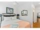Comfortable bedroom with hardwood floors, white linens, and bright natural light from the large window at 509 W Ashley Ave, Folly Beach, SC 29439