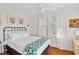 Comfortable bedroom featuring hardwood floors, sheer curtains, and neutral decor at 509 W Ashley Ave, Folly Beach, SC 29439