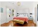 Sun-filled bedroom featuring natural light, hardwood floors, and stylish furnishings at 509 W Ashley Ave, Folly Beach, SC 29439