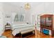 Bright bedroom with hardwood floors, stylish furniture, and comfortable queen bed at 509 W Ashley Ave, Folly Beach, SC 29439