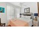 Inviting bedroom with hardwood floors, white linens, and bright natural light from the large window at 509 W Ashley Ave, Folly Beach, SC 29439