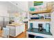 Bright kitchen with stainless appliances, hardwood floors, island with seating, and stylish gold chandelier at 509 W Ashley Ave, Folly Beach, SC 29439