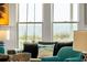 Comfortable living room seating with views of the beach through bright windows at 509 W Ashley Ave, Folly Beach, SC 29439