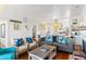 Cozy living room featuring wainscoting, hardwood floors, comfortable seating, and stylish beach-themed decor at 509 W Ashley Ave, Folly Beach, SC 29439
