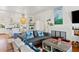 Open-concept living room and kitchen with hardwood floors, stylish decor, and comfortable seating arrangement at 509 W Ashley Ave, Folly Beach, SC 29439
