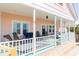 Spacious porch with comfortable seating and a porch swing for relaxation at 509 W Ashley Ave, Folly Beach, SC 29439