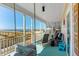 Relaxing porch featuring rocking chairs and a swing, with a view of the ocean and beach walkway at 509 W Ashley Ave, Folly Beach, SC 29439