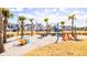 Community playground featuring Adirondack chairs, swings, picnic tables and palm trees at 556 Scholar Way, Summerville, SC 29486