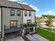 Modern townhome with covered parking, a balcony, and a manicured lawn at 560 Scholar Way, Summerville, SC 29486