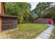 Backyard view features a matching building with a red door and stone paver walkway at 5904 Hagood Ave, Hanahan, SC 29410