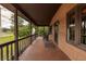 Spacious covered porch with wooden flooring and railing, ideal for outdoor seating at 5904 Hagood Ave, Hanahan, SC 29410