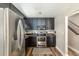 Modern kitchen with stainless steel appliances, black cabinets, and unique flooring at 5904 Hagood Ave, Hanahan, SC 29410