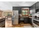 Well-lit kitchen showcasing stainless steel appliances, dark cabinetry, and wooden countertops at 5904 Hagood Ave, Hanahan, SC 29410