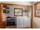 Functional laundry room boasts modern washer and dryer units, complemented by stylish decor and natural light at 5904 Hagood Ave, Hanahan, SC 29410