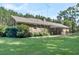 A brick home featuring a well-maintained backyard and lush greenery, creating a serene outdoor space at 598 Maple Branch Rd, Reevesville, SC 29471