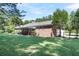 A brick home with an expansive fenced backyard, complemented by mature trees, offering privacy and space for outdoor activities at 598 Maple Branch Rd, Reevesville, SC 29471