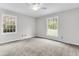Serene bedroom with two bright windows and a classic ceiling fan at 598 Maple Branch Rd, Reevesville, SC 29471