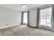 Bright bedroom with ample natural light through dual windows and neutral carpeting at 598 Maple Branch Rd, Reevesville, SC 29471