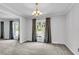 Bright dining room boasts neutral walls, a chandelier, and views of the surrounding landscape at 598 Maple Branch Rd, Reevesville, SC 29471