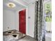 Bright foyer with a red front door, gray patterned tile flooring and a window at 598 Maple Branch Rd, Reevesville, SC 29471