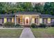Charming brick home with a inviting red door, manicured landscaping, and classic shutters at 598 Maple Branch Rd, Reevesville, SC 29471
