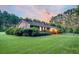 Charming brick home with a lush green lawn and mature trees, perfect for outdoor living at 598 Maple Branch Rd, Reevesville, SC 29471