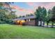 Scenic view of brick home with an attached garage and expansive, well-maintained lawn at 598 Maple Branch Rd, Reevesville, SC 29471