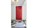 An inviting red front door features a decorative light fixture and attractive tile flooring at 598 Maple Branch Rd, Reevesville, SC 29471