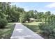 Charming brick home with a long driveway and well-manicured lawn surrounded by mature trees, offering great curb appeal at 598 Maple Branch Rd, Reevesville, SC 29471