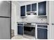 Updated kitchen featuring modern stainless steel appliances and dark blue cabinets at 598 Maple Branch Rd, Reevesville, SC 29471