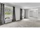 Spacious living room with neutral carpet, gray walls, and natural light from large windows at 598 Maple Branch Rd, Reevesville, SC 29471
