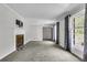 Spacious living room with a fireplace, large windows, and modern neutral paint at 598 Maple Branch Rd, Reevesville, SC 29471