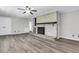Bright living room featuring a painted brick fireplace and hardwood floors at 598 Maple Branch Rd, Reevesville, SC 29471