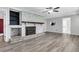 Spacious living room showcases painted brick fireplace and new flooring at 598 Maple Branch Rd, Reevesville, SC 29471