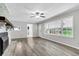 Open floor plan features updated floors and brick fireplace at 598 Maple Branch Rd, Reevesville, SC 29471