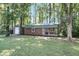 Large yard with a shed featuring an attached garage door and covered front porch with black railings at 598 Maple Branch Rd, Reevesville, SC 29471