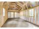 New shed with exposed studs and rafters; partially insulated with two windows and double doors at 598 Maple Branch Rd, Reevesville, SC 29471