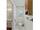 Half bathroom featuring white toilet, tile floors, and sink with wood cabinets at 604 Longstreet St, Summerville, SC 29486