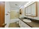 Bathroom with tiled tub/shower, vanity with storage, and patterned flooring at 604 Longstreet St, Summerville, SC 29486