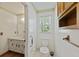 Bright bathroom features white vanity, toilet and window at 604 Longstreet St, Summerville, SC 29486