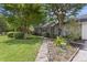 Landscaped front yard with a stone walkway leading to a cozy single-story home at 604 Longstreet St, Summerville, SC 29486