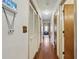 Long hallway with hardwood floors, closet, light and view of living room at 604 Longstreet St, Summerville, SC 29486