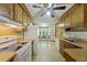 View of kitchen with wood cabinets, white appliances, and a dining area at 604 Longstreet St, Summerville, SC 29486