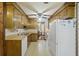Galley kitchen with wood cabinets, white appliances, and laminate countertops at 604 Longstreet St, Summerville, SC 29486