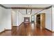 Spacious living room with hardwood floors, a brick fireplace, ceiling beams, and exposed brick at 604 Longstreet St, Summerville, SC 29486