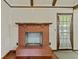 Living room with brick fireplace, wood flooring, and natural light at 604 Longstreet St, Summerville, SC 29486