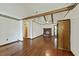 Open-concept living room with hardwood floors, fireplace, and beamed ceiling at 604 Longstreet St, Summerville, SC 29486
