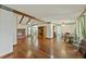 Spacious living room with hardwood floors, brick fireplace, ceiling fans, and adjacent dining area at 604 Longstreet St, Summerville, SC 29486